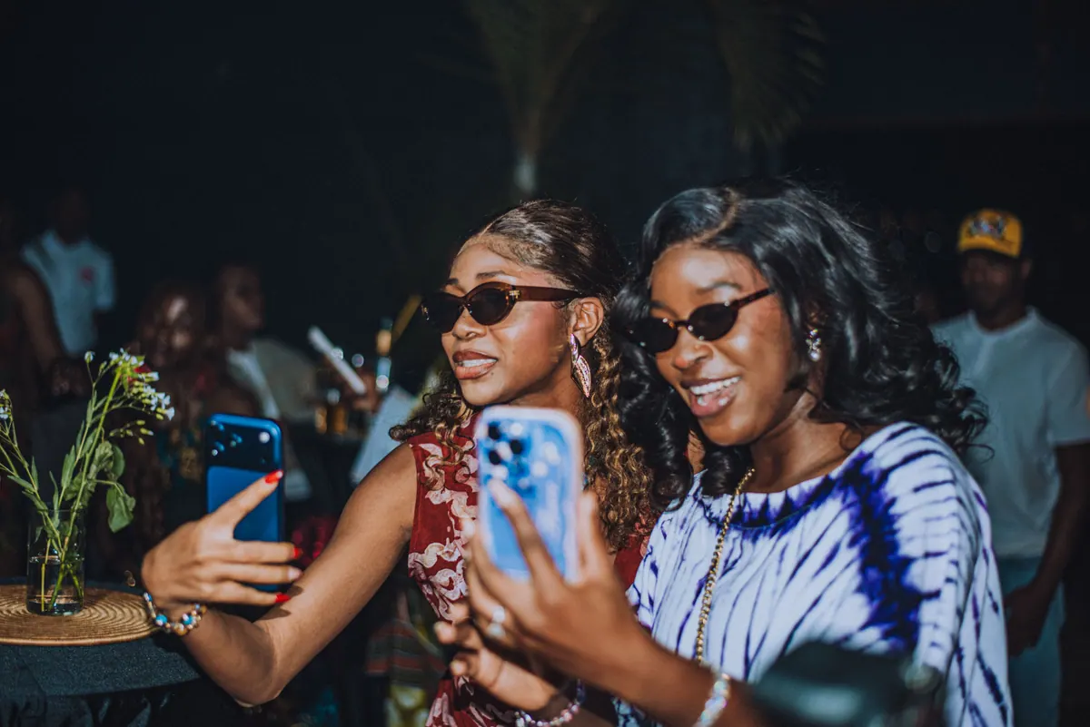 Two women in sunglasses take a selfie together at the awards night